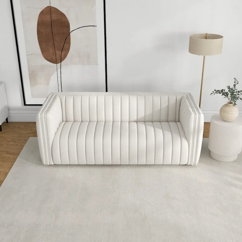 Canapé trois places dossier touffeté en tissu bouclé crème