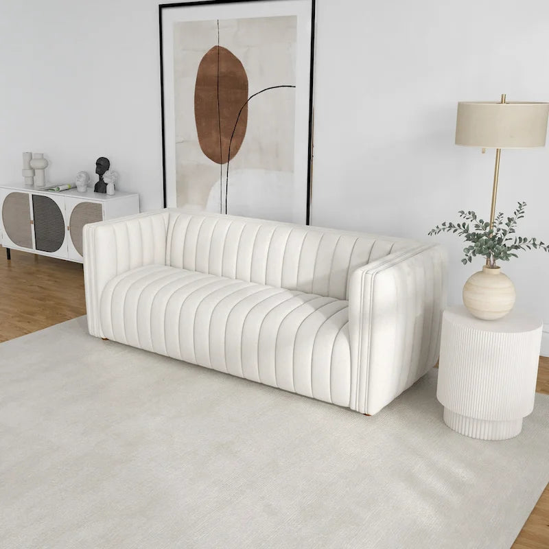 Canapé trois places dossier touffeté en tissu bouclé crème