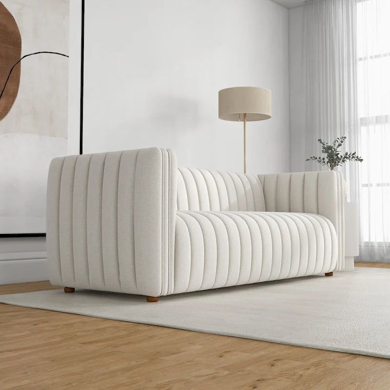 Canapé trois places dossier touffeté en tissu bouclé crème